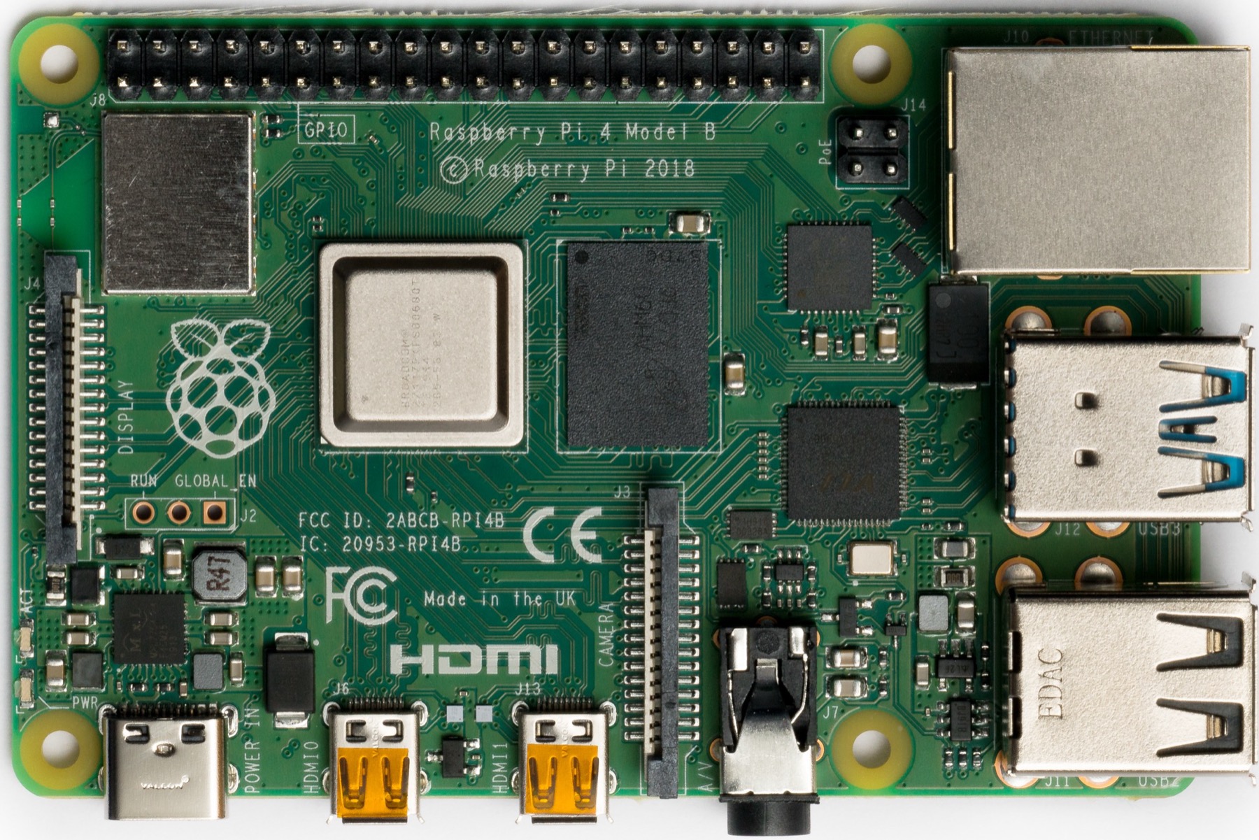 A green Raspberry Pi 4 circuit board seen from above, with its chips, pins and USB ports.